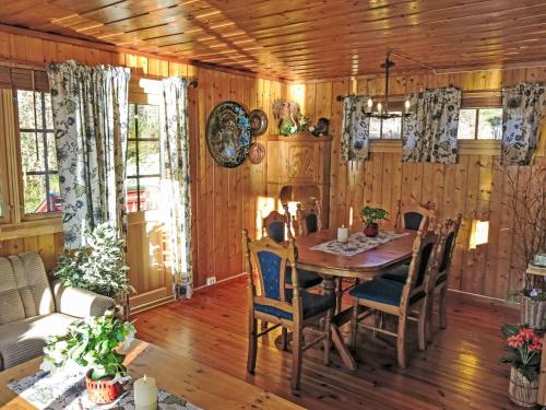 a dining room with a table and chairs at Holiday Home Midtholmen by Interhome in Konsmo
