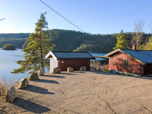 a couple of buildings next to a body of water at Holiday Home Midtholmen by Interhome in Konsmo