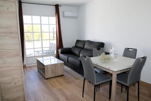 a living room with a table and a couch at Luna de Mojácar in Mojácar
