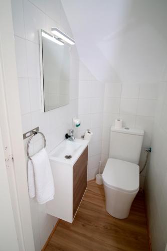 a white bathroom with a toilet and a sink at Luna de Mojácar in Mojácar