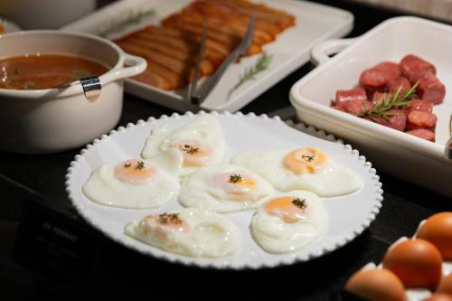 a plate of food with deviled eggs on a table at Hotel Lyon in Barcelona