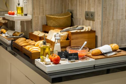 a buffet with bread and other foods on a table at Hotel Lyon in Barcelona