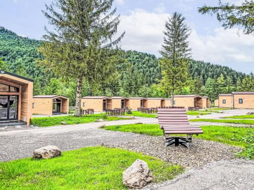 a park with a bench and a row of barracks at Holiday Home Tiny Haus Glockenalm-Wendelsteinblick by Interhome in Aurach