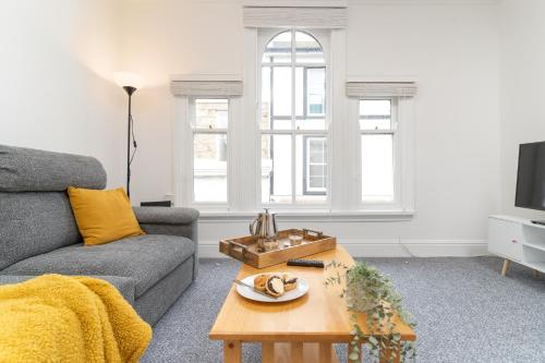 a living room with a couch and a coffee table at Bright~ Town Center~ 2 bed~Penzance in Penzance