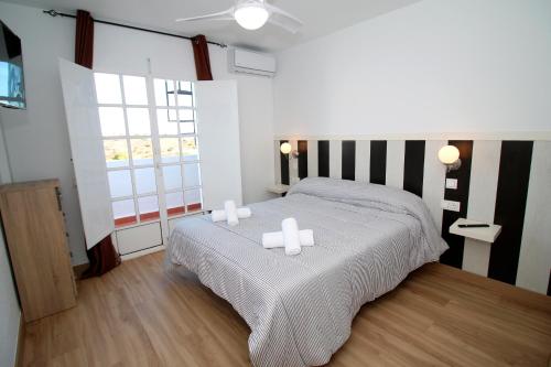 a bedroom with a bed with two candles on it at Luna de Mojácar in Mojácar