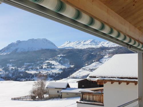a view of a snow covered mountain from a house at Apartment Pardi 3 Simeon by Interhome in Lenz