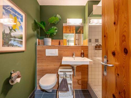 a bathroom with a toilet and a sink at Apartment Steil Alva Studios Smit by Interhome in Lenzerheide