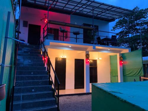 a staircase leading up to a house at night at H et L in Tortuguero