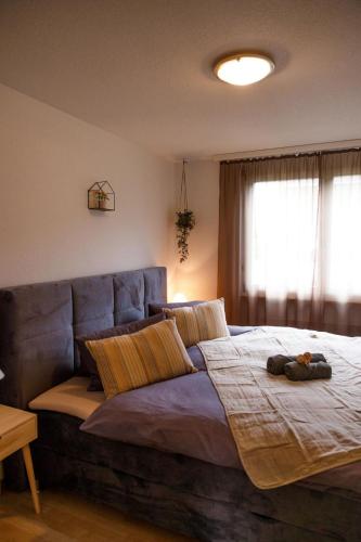 a bedroom with a large bed with a blue headboard at Apartment Mountain View by Interhome in Frutigen