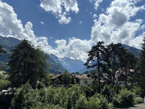 a view of a village with trees and mountains at Apartment Mountain View by Interhome in Frutigen