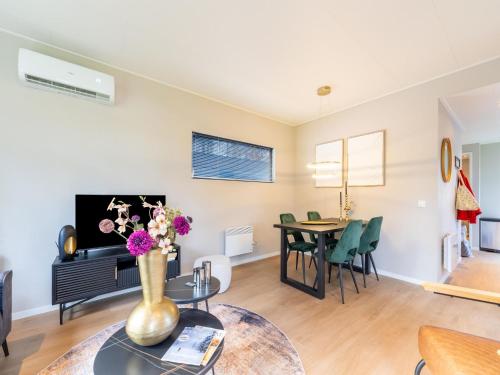 a living room with a vase of flowers on a table at Vacation Home in Haarle near Hellendoorn in Haarle