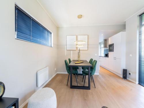 a dining room with a table and green chairs at Vacation Home in Haarle near Hellendoorn in Haarle