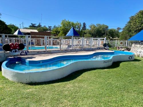 a large swimming pool in the grass in a park at Atrapa Sueños I in Embalse