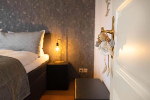 a bedroom with a bed and a door with a stuffed animal at Ferienwohnung Menden in Menden