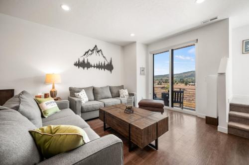 a living room with a couch and a table at Snowbasin Chalet in Morgan