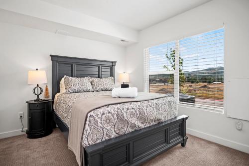 a bedroom with a bed and a large window at Snowbasin Chalet in Morgan