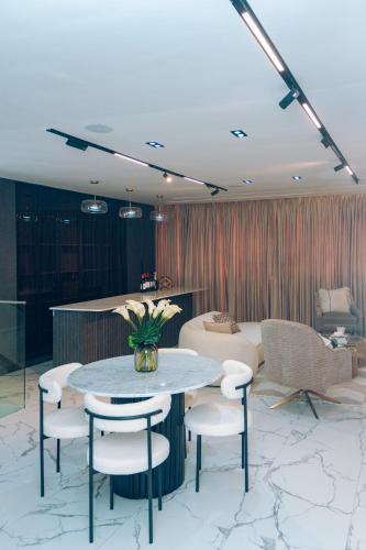 a room with a table and chairs and a couch at Wakatee Apartments - Luxury 2 bedrooms Apartment in Victoria Island