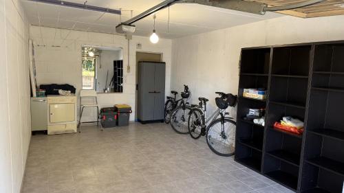 a garage with two bikes parked in a room at Rose e Frutta - Sweet Dreams in Begliano