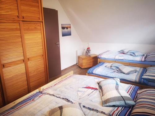 a bedroom with two beds and a rug on the floor at Landurlaub Mecklenburgische Seenplatte B Waren Müritz in Schwarzenhof