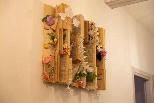 a wall decoration with flowers and books on a wall at Luz de Salento B&B in Lecce