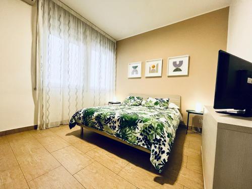 a bedroom with a bed and a window and a television at Le Dimore del Corso in Catania