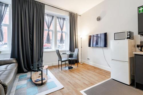a living room with a couch and a table at Stunning Ground Floor flat in Southside. in Glasgow