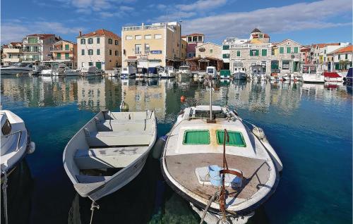 two boats are docked in a harbor with buildings at Lovely Home In Krkovic in Prović