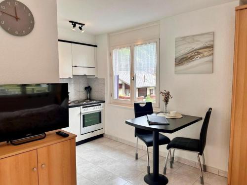 a kitchen with a table and a dining room at Apartment Alcazar by Interhome in Saas-Grund