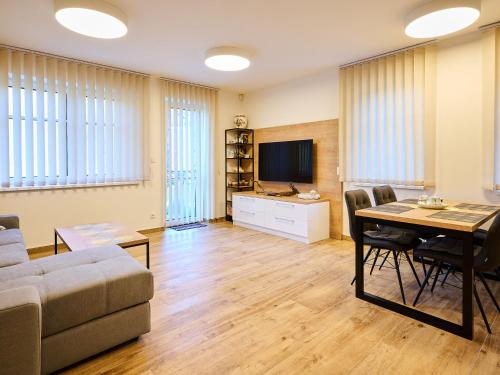 a living room with a table and a couch at Apartment Markéta by Interhome in Smržovka