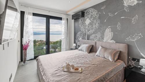 a bedroom with a large bed with shoes on it at Villa Gabi by Villas Holiday in Donji Rukavac