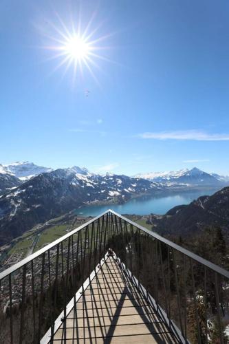 a viewing platform with a view of a lake and mountains at Apartment Lilo-4-Zimmer by Interhome in Beatenberg