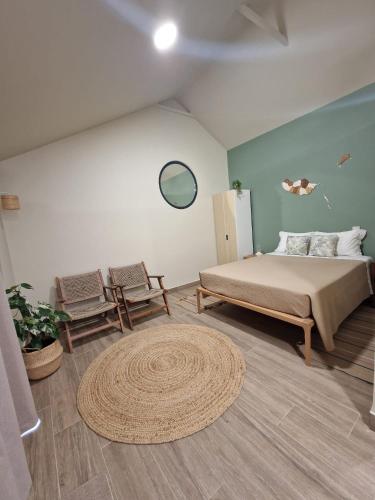 a bedroom with a large bed and a rug at Favinha Rooftop in Machico