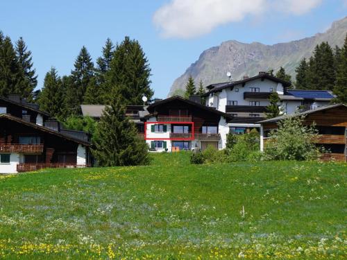 a group of buildings in a field of grass at Apartment Stgirat Bellaval by Interhome in Valbella