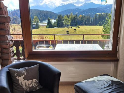 a window with a view of a field with cows at Apartment Stgirat Bellaval by Interhome in Valbella