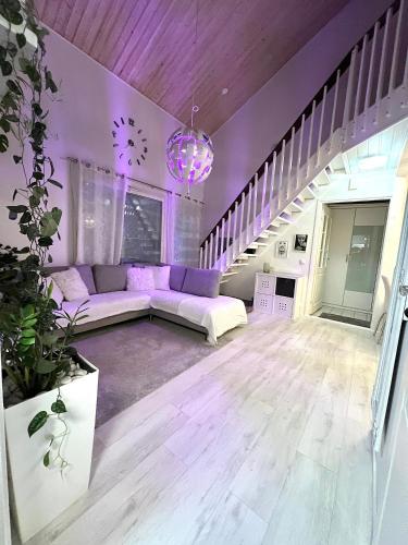 a living room with purple furniture and a purple ceiling at Hopea Villa in Vuokatti
