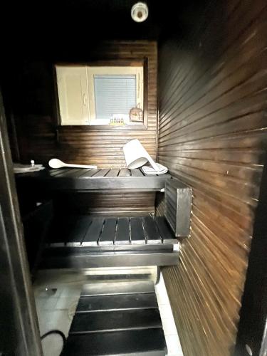 an empty sauna with a phone and a book in it at Hopea Villa in Vuokatti
