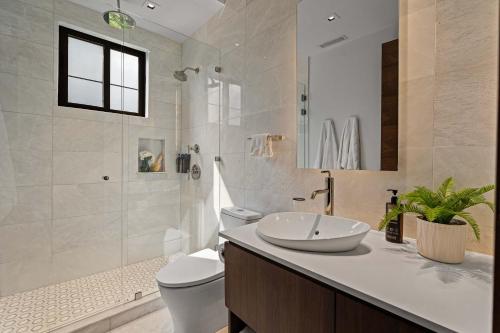 a bathroom with a sink and a toilet and a shower at Beautifully Remodeled Condo w - Pool in Playa Conchal