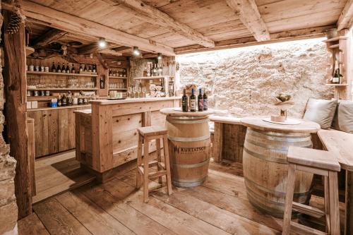 a bar with a counter and barrels in a room at Chalet Mornà in San Martino in Badia