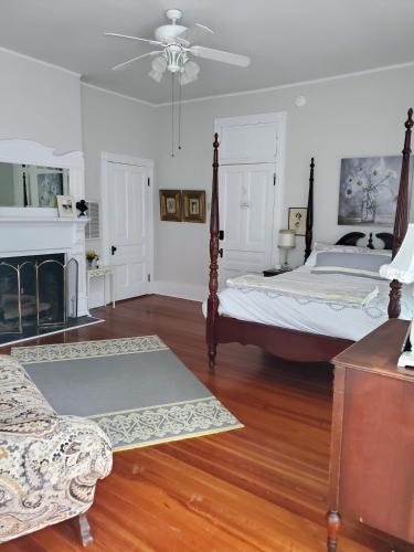 a bedroom with two beds and a fireplace at The Old Buggy Inn in Carthage