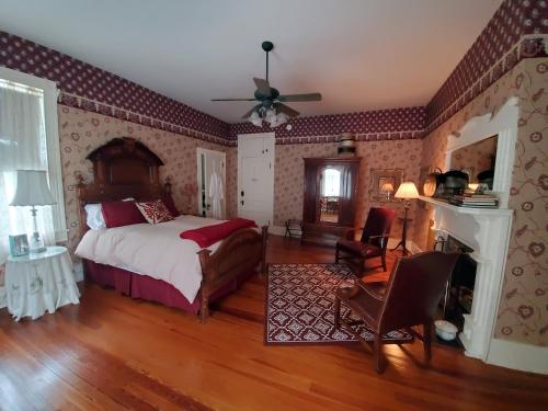 a bedroom with a bed and a fireplace at The Old Buggy Inn in Carthage