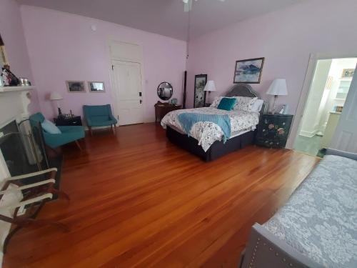 a bedroom with two beds and a wooden floor at The Old Buggy Inn in Carthage