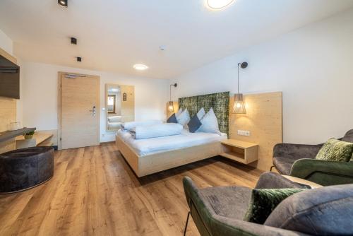 a bedroom with a bed and a living room at Haus Gstrein in Obergurgl