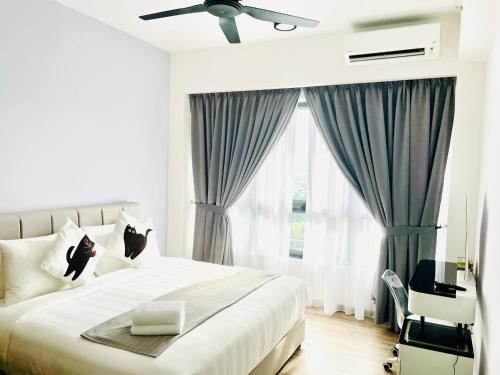 a bedroom with a bed with two cats sitting on it at Agile TRX Luxury suite Bukit bintang in Kuala Lumpur