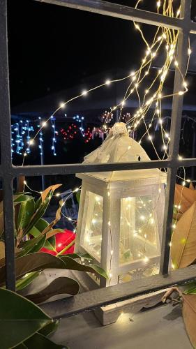 a lit up lantern with lights in a window at B&B Luna in Castelvetro di Modena