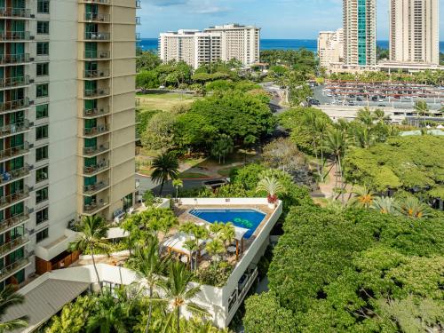 an aerial view of a resort with a pool and buildings at Luana Waikiki Hotel & Suites in Honolulu