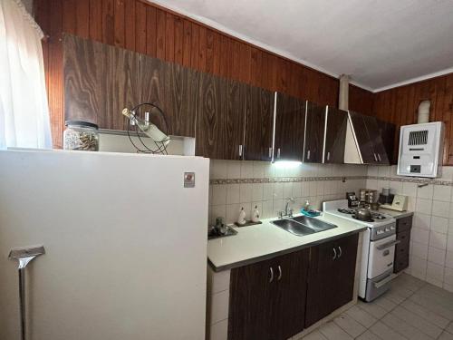 a kitchen with a white refrigerator and a sink at Casa catamarca in San Rafael