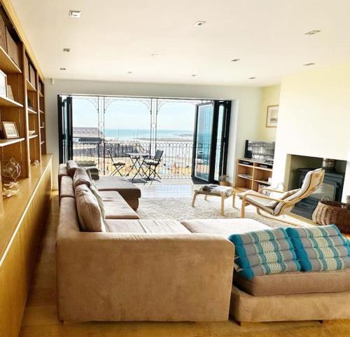 a large living room with a couch and a fireplace at Ancient Lights -Broadstairs Pier in Kent