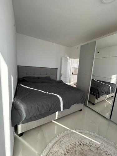 a bedroom with a bed and a mirror at Holliday Tivat in Peani