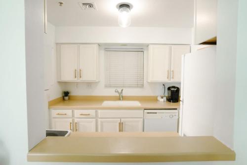 a kitchen with white cabinets and a sink at Stunning Riverfront Getaway in Downtown Nashville in Nashville