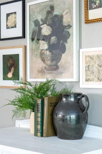 a vase sitting on a table with a book and a book at Stunning Riverfront Getaway in Downtown Nashville in Nashville